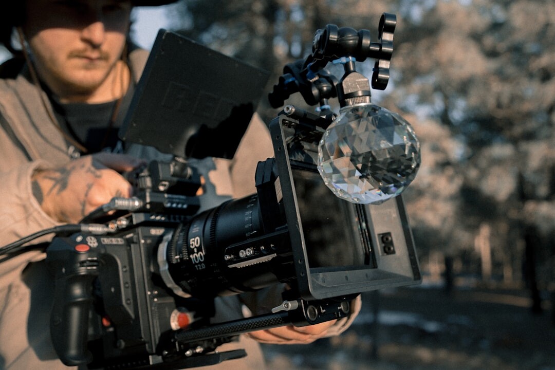 Camera operator filming with a professional broadcast camera