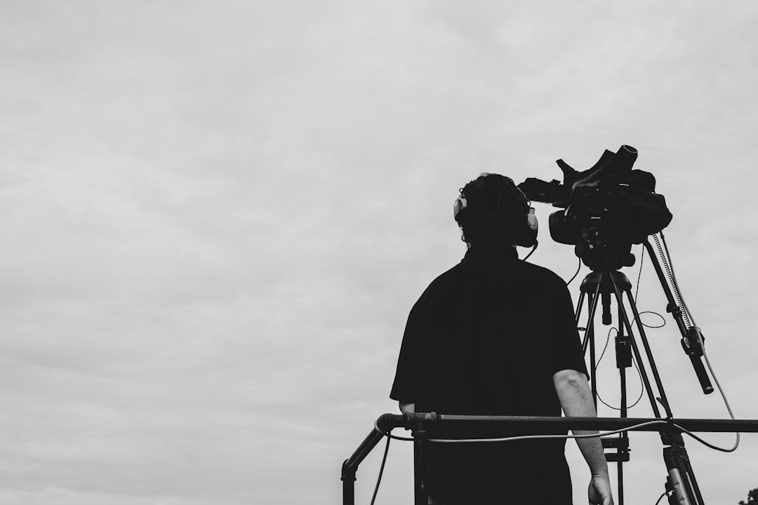 Television director watching multiple broadcast monitors